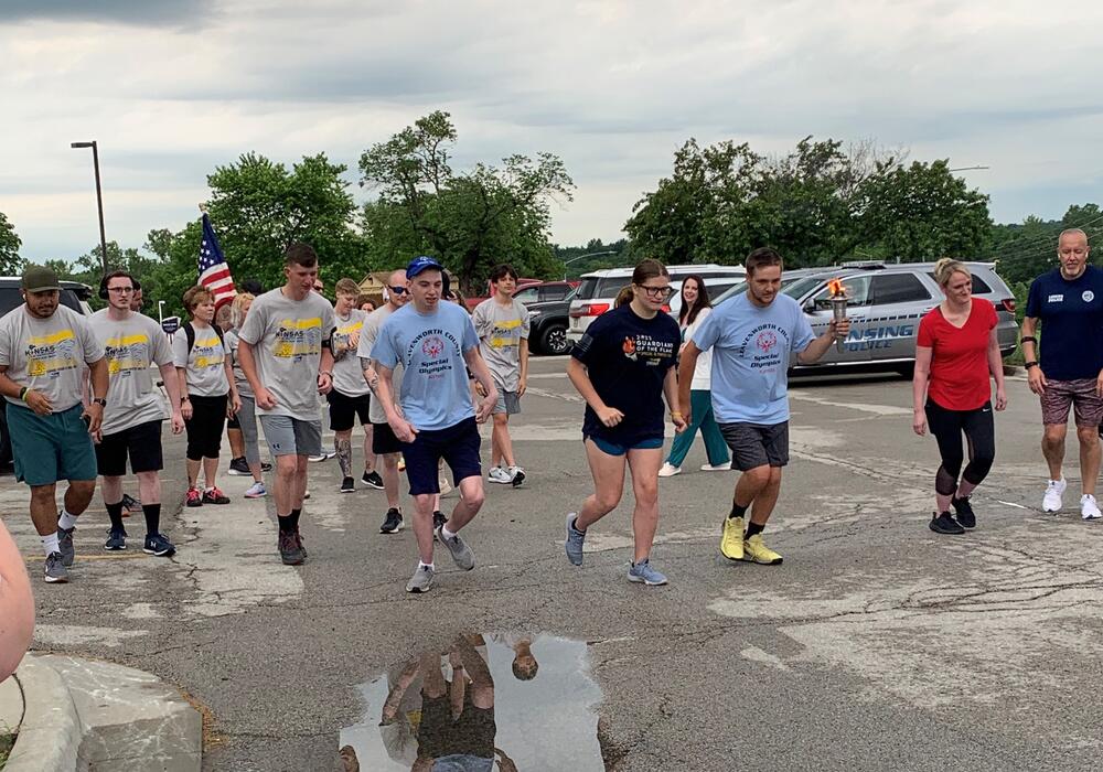 large group of people running through Leavenworth participating in the 2024 Torch Run